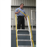 Man standing on a mezzalad ladder with yellow railings against a building background
